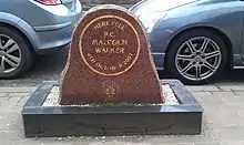  "a piece of brown marble inscribed: 'Here fell PC Malcolm Walker 4th October 2001 West Midlands Police', with a black stone base"