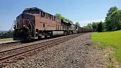 The Pennsylvania Railroad heritage unit, GE ES44AC #8102, leads an empty coal drag on track 1.