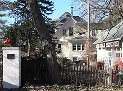 Park Hill, photographed from S 41st St. Visible in the photo are the contributing features of the garage and residence, as well as a plaque designating the area as a historic place.