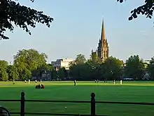 An open stretch of grassland looking towards a church