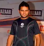 A man wearing dark blue t-shirt with ICC worldcup 2011 logo.