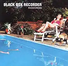 A woman resting on a sun lounger next to a pool