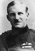 Portrait of moustachioed man in military uniform with pilot's wings on chest