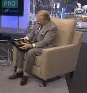 Peterffy holding his computer in an interview