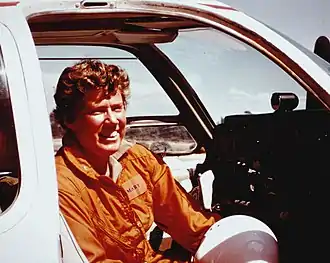 Photo of Mary Barr sitting in the cockpit of her transport plane, 1975