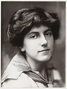 A head-and-shoulders photograph of a young white woman with dark hair dressed in an updo