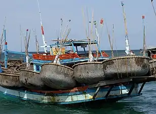 Fishing boat with its collection of basket boats (thuyền thúng)