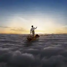 A man in a white shirt and tan pants stands in a Thames skiff at the center of the image. He stand-up paddles the Thames skiff across a sea of clouds, heading towards the sun.