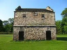 Doocot (English 'Dovecote') at Pinkie House with Seton's characteristic cipher of a crowned crescent and cinquefoil over door to right