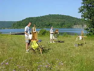 En plein air painters painting in Ringwood, New Jersey. Artists are using a French easel on the left of picture, and a Pochade box on the right.