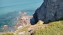 Photo showing a view down Eastcliff down towards the sea and the tidal pool in the rocks.