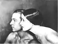 Busts of a man and woman, both facing left