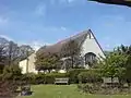 A view of Prittlewell Priory, Southend-on-Sea, from an adjacent garden in the surrounding Prittlewell Park.