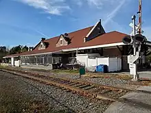 A reused railway station next to a single track