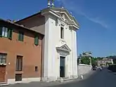  A two story building with a classical pediment and pillars