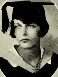 A young white woman wearing an academic cap and gown