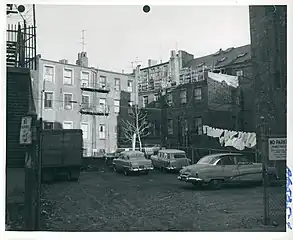 Courtyard with cars and laundry