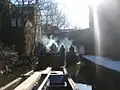 Wooden boat convoy picking up recyclables on Ashton Canal