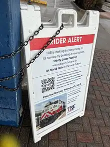 Signage at CentrePort/DFW Airport station announcing the future closure and replacement of Richland Hills station. The text says "RIDER ALERT: TRE is making improvements to its service by building a new station. Trinity Lakes Station will replace the one in Richland Hills in the near future. During construction, a temporary schedule change will be implemented to accommodate building the station platform. Please refer to the TRE website and printed schedules for more details about the schedule changes. Effective Monday, February 13, 2023.