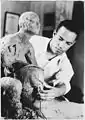 Sculptor Richmond Barthé working on a clay figure, n.d.