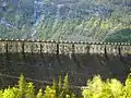 The dam is crowned by the dates 1910–1918 and initials of the managing director Ragnvald Blakstad. The letters are 4 m high