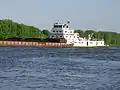 M/V Bill Berry of the Ingram Barge Company pushing cargo barges up the Mississippi River at Dubuque, Iowa