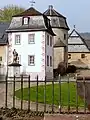 Curved form of a mansard roof with bell-cast eaves, Rommersdorf Abbey, Rheinland-Pfalz, Germany