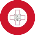 The roundel on the wings and fuselage of Maltese military aircraft consists of a George Cross proper fimbriated in red in the centre of a white disc, within a red disc. Whenever then national flag is painted on the side of an aeroplane, the hoist should be towards the front of the plane with the fly flowing aft.