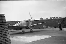 Circular airfield dispersal protected by a high wall of filled sandbags in a C layout