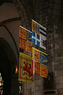 The Royal Standard of the United Kingdom used in Scotland and (clockwise) those of the Prince Philip, Duke of Edinburgh, Anne, Princess Royal (Scottish variant) and Duke of Rothesay, displayed in St Giles' Cathedral, Edinburgh.