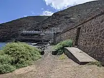 Old fortification and fuel offloading boom at the harbour