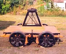 A handcar, in original condition (at the Shelburne Falls Trolley Museum). The foot brake operating mechanism may be seen between the wheels.