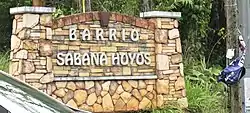 Rock wall Sabana Hoyos sign