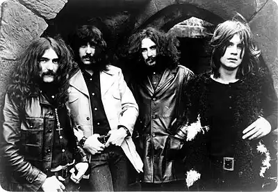 Black-and-white photograph of four long-haired men