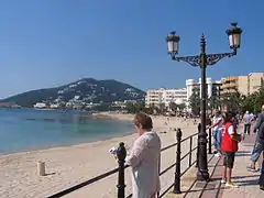 Seafront and beach with the hill 'Puig d’ en Fita' in the background.