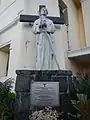 A statue of St. Pedro Bautista next to the original façade