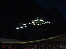 illuminated temple shrine seen in the dark hill