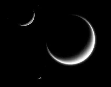 Mimas (smallest) together with Rhea and Titan in crescent shape, forming a triple crescent.