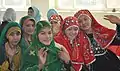 Hazara girls (right) wearing red traditional dress sitting next to Tajik and Pashtun girls in Ghazni, Afghanistan.