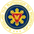 An alternate version of the 1981 seal. The triangle was inverted, and the Sea-lion of Manila was changed to an eagle. The text would also be in script and, together with the ring of stars set against the circular field, are rendered in gold color.