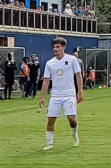 Player standing on the pitch waiting for action to resume