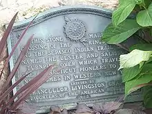 Close-up view of a plaque briefly describing the history of the adjacent road.