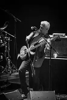 black-and-white picture of Shri Sriram playing a stringed instrument onstage