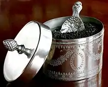 A silver plated tea caddy and a caddy spoon