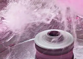 The spinning head of a cotton candy machine