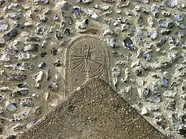 A photograph of St Andrew's tide dial in Bishopstone, East Sussex, England