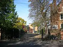 The rear entrance of St Hugh's College, at the northern end of Winchester Road at the junction with Canterbury Road.