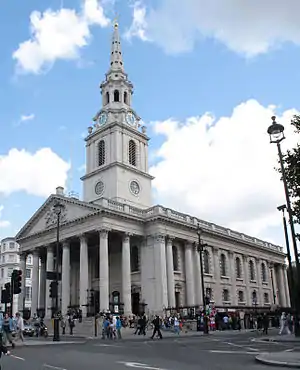 A gray stone church, seen from an angle, with a colonnaded portico on the front and steeple similar to First Congregational's