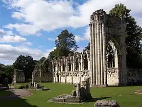 Pointed arched windows and entrance with columns are all that is left of the church.