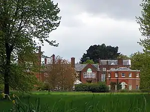 An English country house surrounded by trees